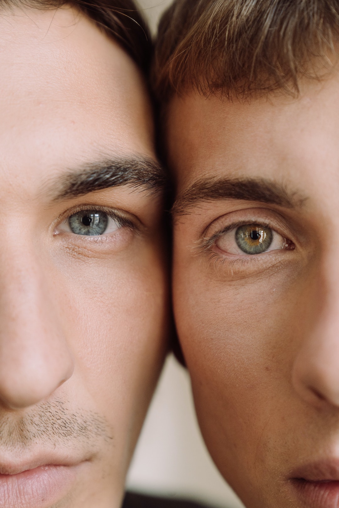 Close-up View Of Two Faces Of Men