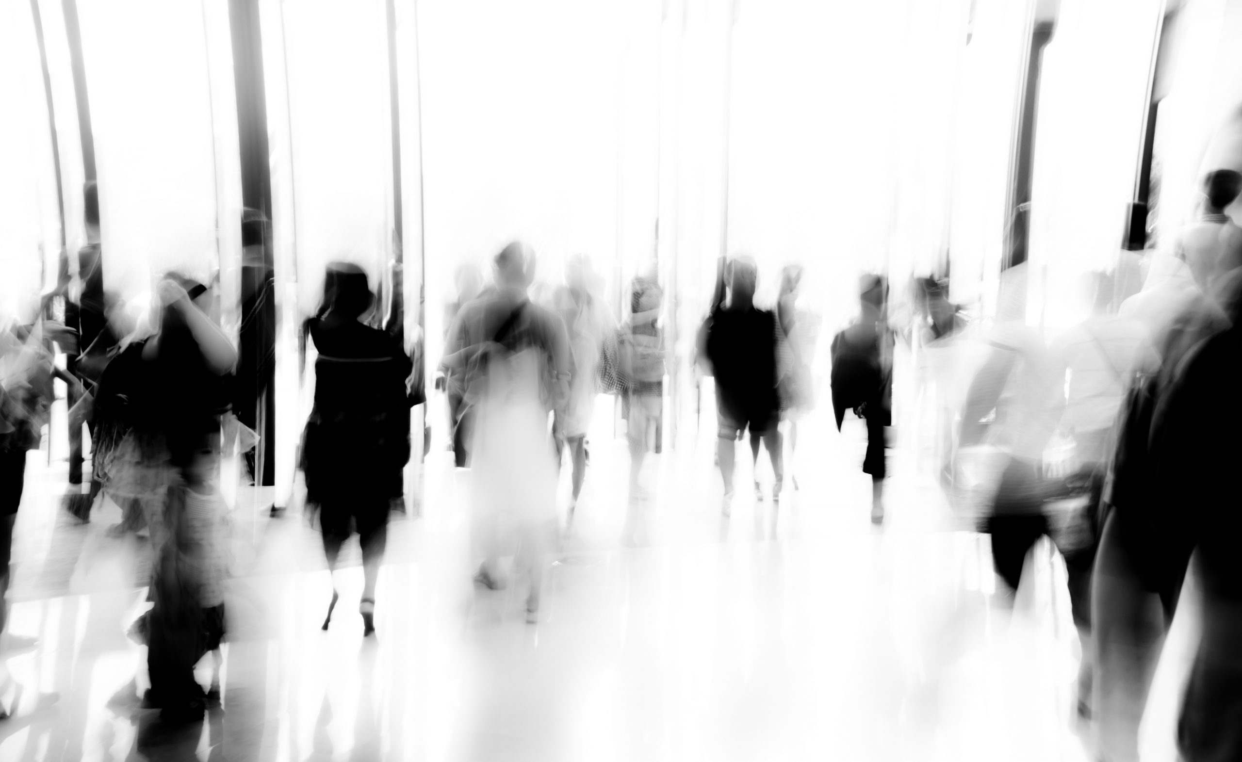 business people activity standing and walking in the lobby motion blurred black and white