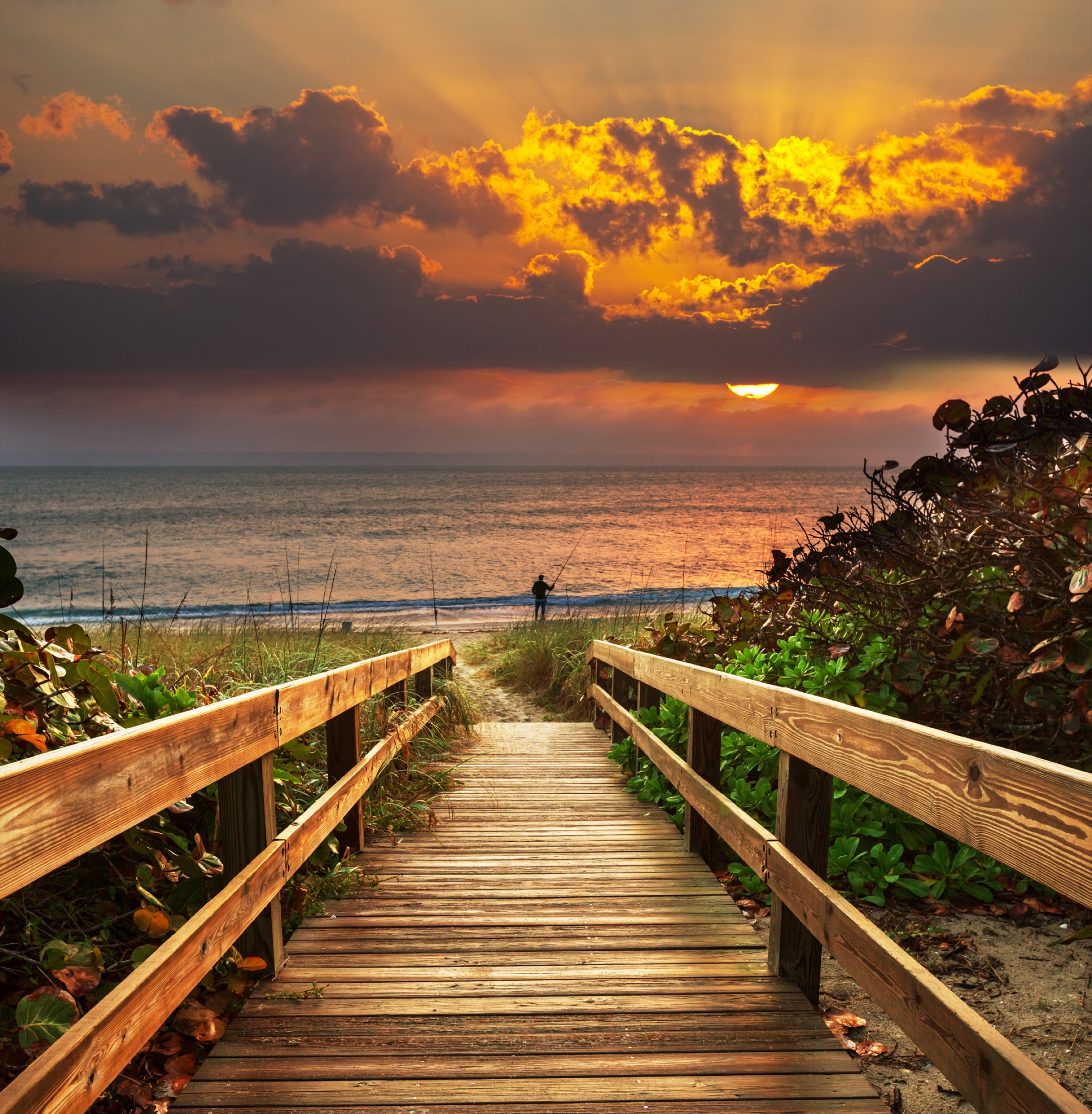 Boardwalk on beach at sunrise
